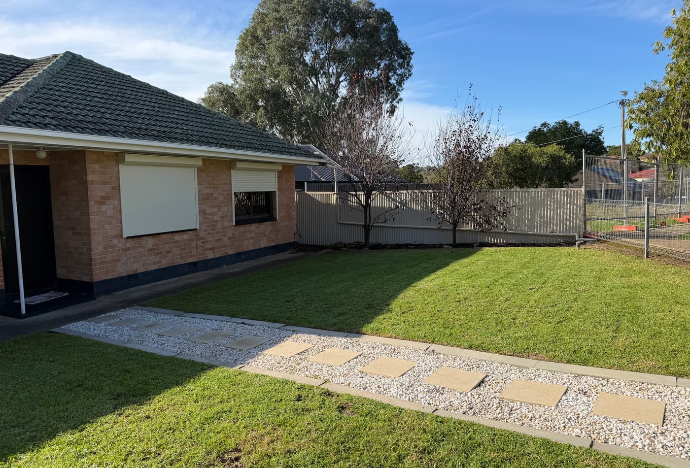 Freshly mown front lawn and paved path at a home in Valley View, Adelaide